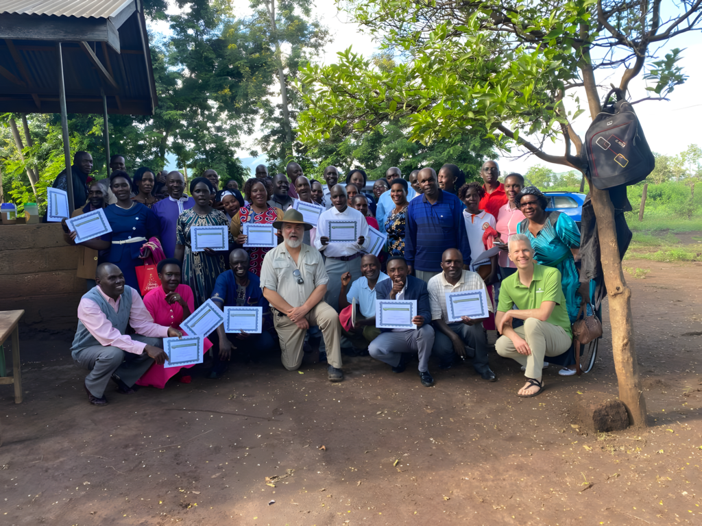 a group of trainees pose with their certificates